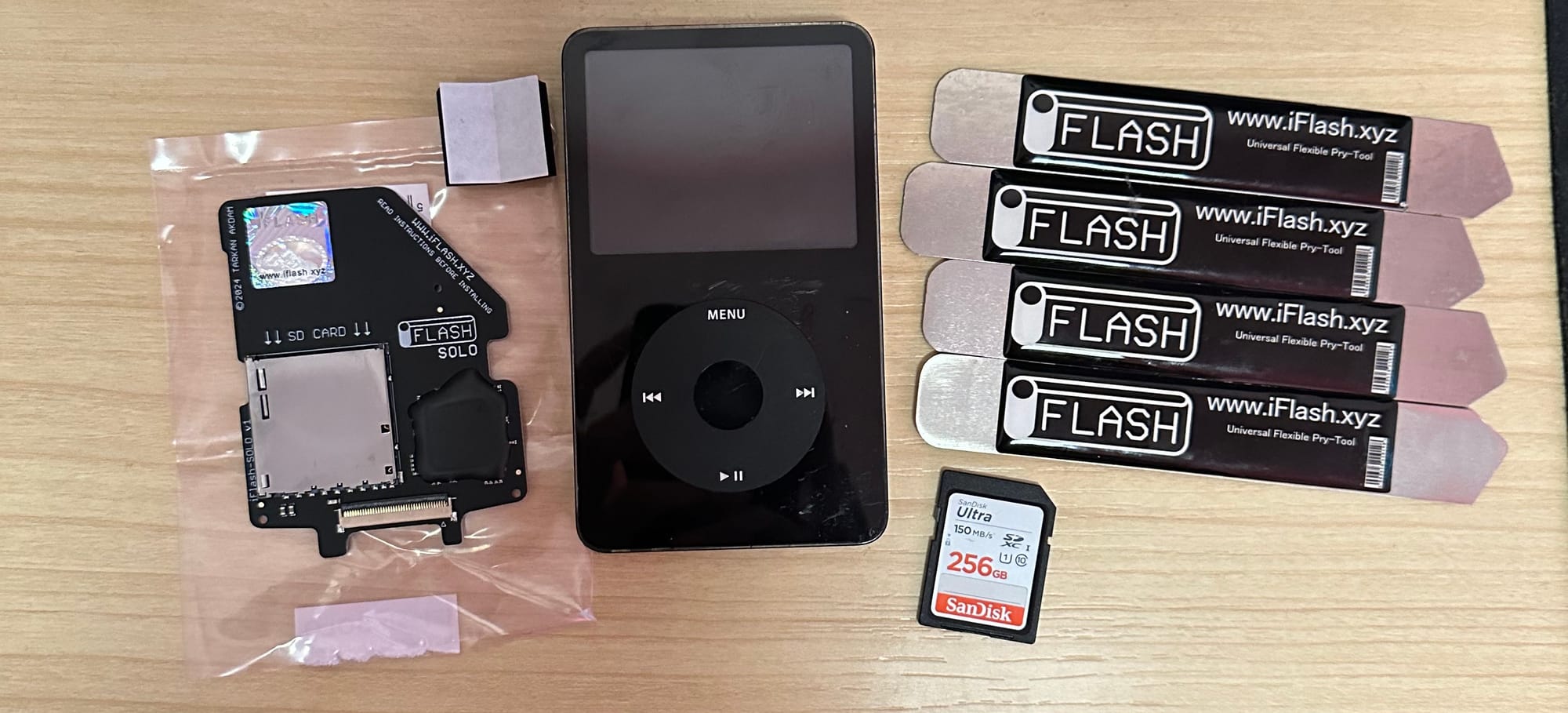 Photo of iPod, opening tools, and iFlash Board, SD Card.